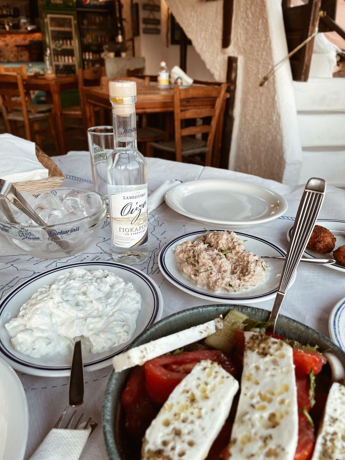 A shared Mediterranean dinner table in the evening sun