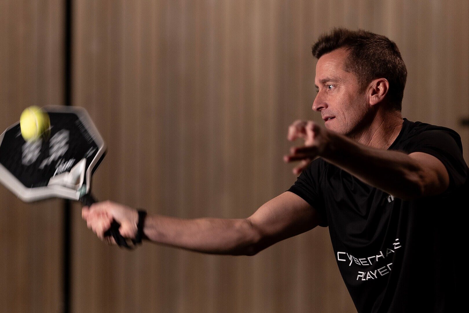 Padel player striking the ball with a STIGA Cybershape racket
